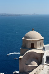 Fototapeta na wymiar A white church in front at the sea on Santorini's island, Greece