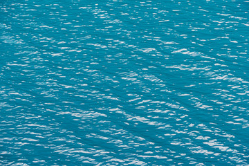 Smooth surface of lake with blue water, turquoise sea as background