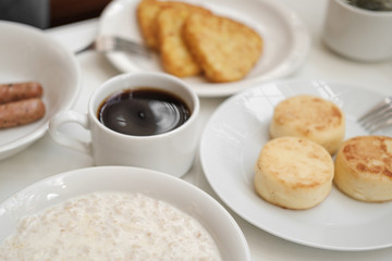 cheese pancakes, sausages, oatmeal, hash browns and coffee