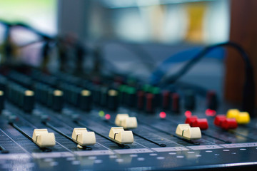 Slide the volume of the audio mixer on the console in the recording and editing work.