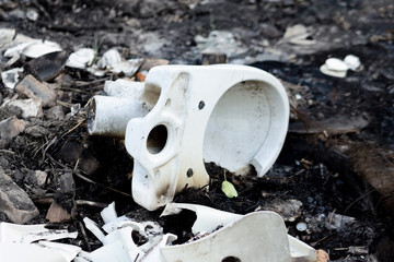 Broken glass, toilet bowl, bottles after a fire. Hard rubbish. Environmental pollution