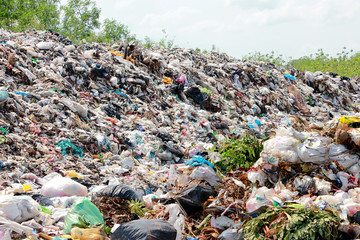 Mountain garbage, large and degraded garbage pile, Pile of stink and toxic residue, waste plastic bottles and other types of plastic waste site in trash dump or landfill. Pollution concept.