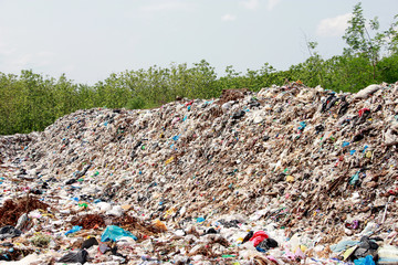 Mountain garbage, large and degraded garbage pile, Pile of stink and toxic residue, waste plastic bottles and other types of plastic waste site in trash dump or landfill. Pollution concept.