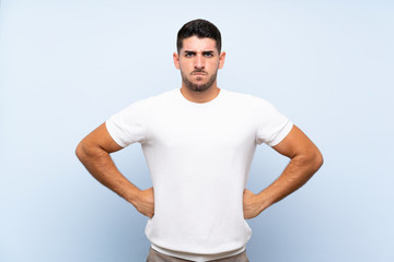 Caucasian handsome man over isolated blue background angry