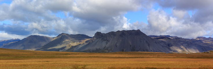 Panorama of grassland and volcanic terrain 