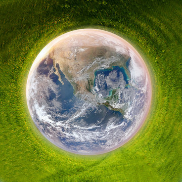 earth surounded by green grass, clean planet concept, earth day background - elements of this image are furnished by NASA