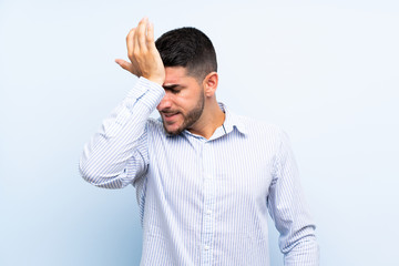 Caucasian handsome man over isolated blue background having doubts with confuse face expression