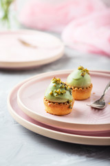 Obraz na płótnie Canvas Small tasty cakes with pistachio mousse