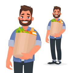Happy man holding a grocery bag in his hands. Buyer at the supermarket