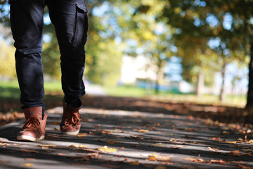 Autumn Park man walking along a path foliage