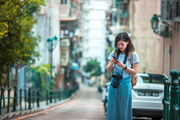 Obraz premium Asian women with camera Traveling in Macau.