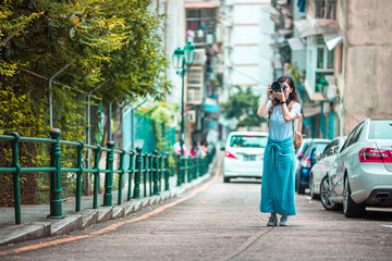 Fototapeta premium Asian women with camera Traveling in Macau.