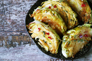 Selective focus. Macro. Grilled cabbage slices with aromatic herbs.