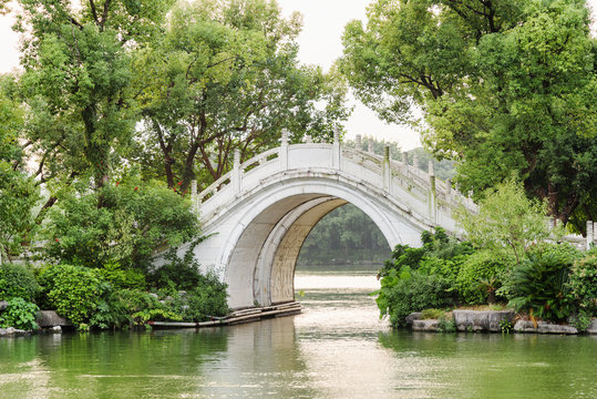 Evening view of white twin marble bridge on lake. Guilin