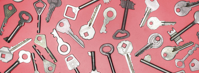 Keys set on pink background. Door lock keys and safes for proper