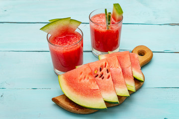 Fresh juice of watermelon, smoothie, cocktail. Sweet summer dessert, slices on wooden cutting board