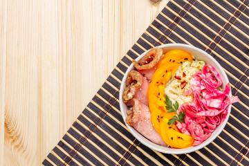 Tasty oriental noodles bowl. Pork, fermented cabbage, tomatoes, hot peppers, sesame seeds