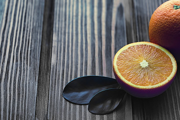 Orange citrus fruit on a stone table. Orange background.