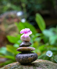 Stacked pebbles in the garden. Zen, spa or wellness concept.