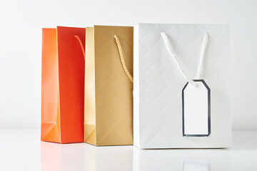 Three colorful paper shopping bag on a white background