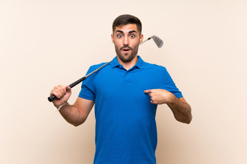 Young handsome golfer man over isolated background with surprise facial expression