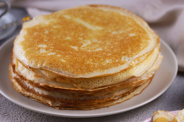 Breakfast with pancakes on a textured background