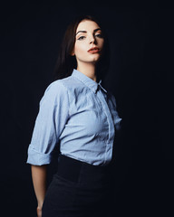 Young beautiful Jewish girl in office clothes on a black background.