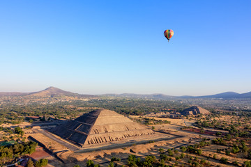 Hot air ballon  in light-blue sky over the pyramids of Teotihuacan Sun and Moon in Mexico