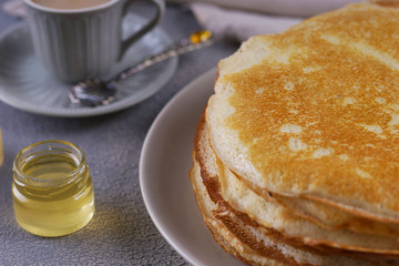 Breakfast with pancakes on a textured background