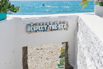 The sign with text and beautiful azure sea