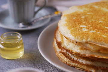 Fototapeta na wymiar Breakfast with pancakes on a textured background