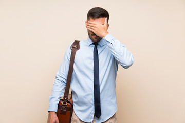 Young business with beard over isolated background covering eyes by hands