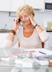 Woman among pills calling to doctor