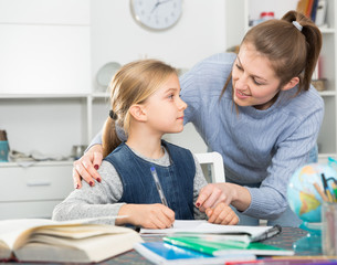 Mother checks school lessons daughters