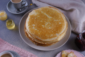 Breakfast with pancakes on a textured background