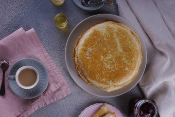 Breakfast with pancakes on a textured background