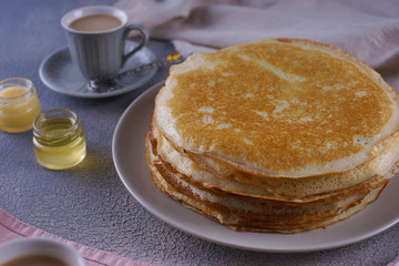 Breakfast with pancakes on a textured background