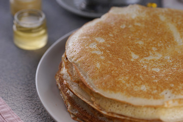 Fototapeta na wymiar Breakfast with pancakes on a textured background