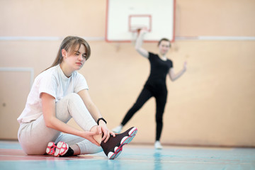 Girl in the gym playing a basketball