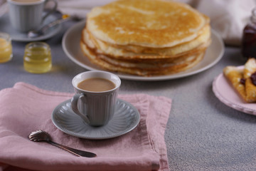 Breakfast with pancakes on a textured background