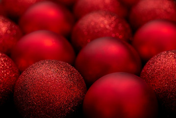Red Christmas balls close up. Christmas background. Lots of shiny beautiful Christmas balls. Decoration for the new year.
