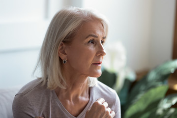 Close up image serious pensive sad aged female