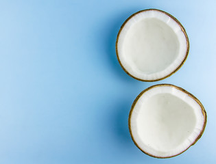 split coconut lies against a blue background