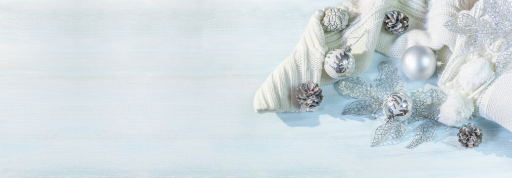 Winter, christmas balls and warm sweater on a wooden table background. Panoramic image