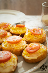 Homemade sandwiches with egg, cheese and tomatoes on a plate