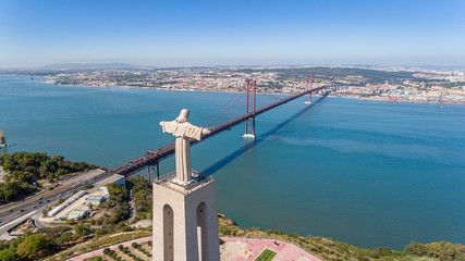 Aerial. Panorama from sky with a drone, a bridge on April 25 and a statue of Jesus Christ. Lisbon Portugal.