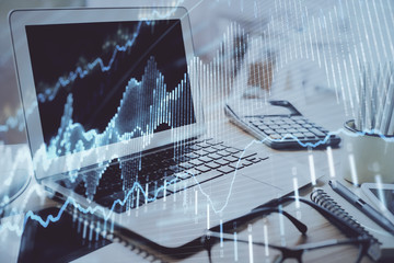 Forex Chart hologram on table with computer background. Multi exposure. Concept of financial markets.