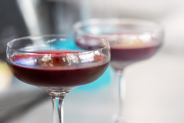 two wide glasses of pomegranate red wine, close-up
