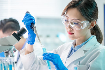 Asian scientist take test tube