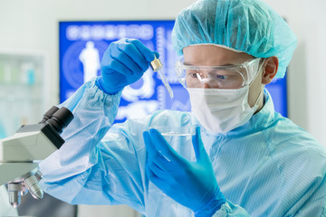asian scientist take petri dish